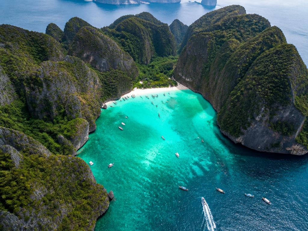Aerial view of limestone islands and longtail boats in southern Thailand